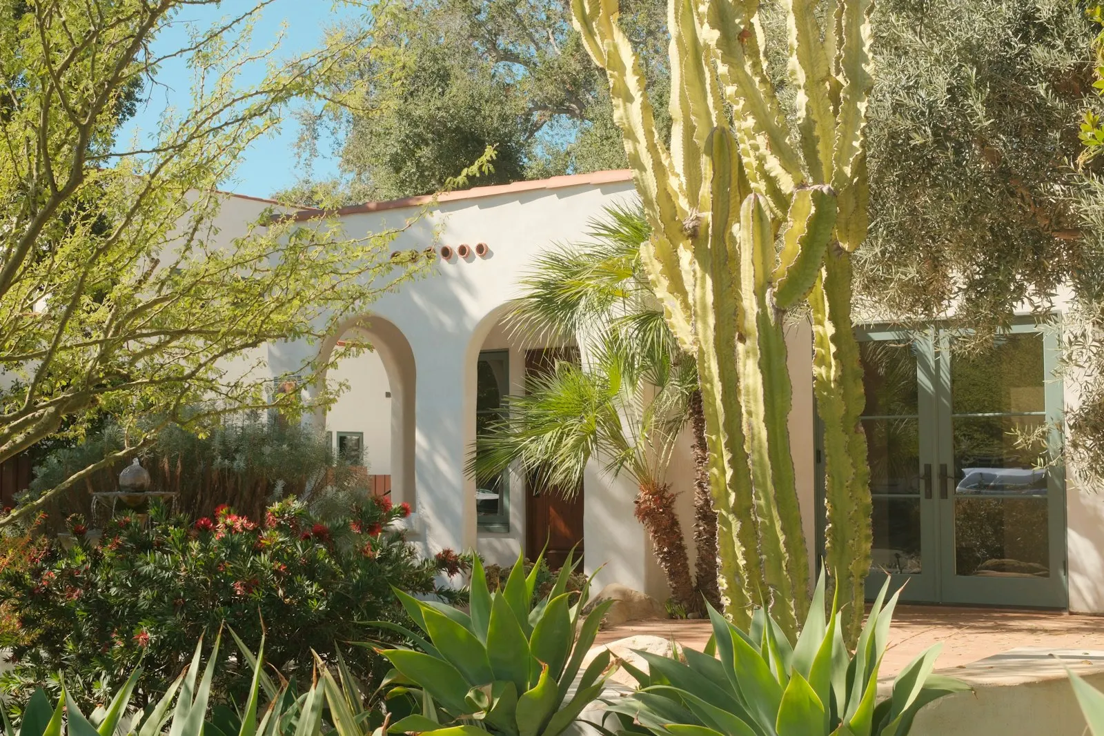 Spanish-style Tempe-area home with desert landscaping and a clean DG path.